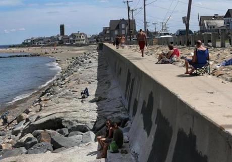 People sunbathed Thursday on Marshfield’s Brant Point beach, which has lost a lot of sand.
