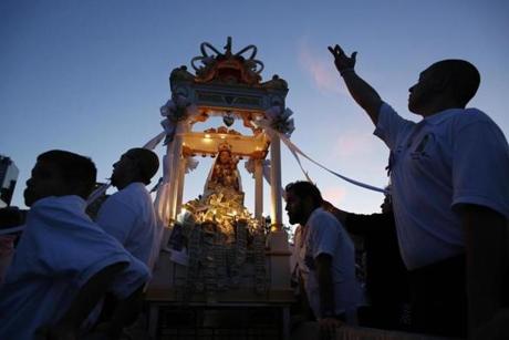 Men carried the statue of the Madonna del Soccorso for a procession around the North End during the Fisherman’s Feast.
