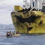 Volunteers searched near the damaged cargo ship Sulpicio Express Siete Saturday, a day after it collided with a passenger ferry near central Philippines. 