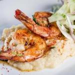 In the shrimp and grits dish at Sam’s in Louis Boston, the shrimp are sauteed in whiskey, the grits spicy with jalapeno. 