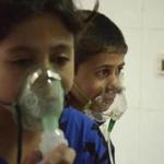 Children, affected by what activists say was a gas attack, breathed through oxygen masks in a Damascus suburb. 