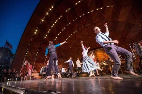 Jake Novak (right) and other cast members of “Kiss Me, Kate” performing a musical number on the Hatch Shell stage Wednesday.
