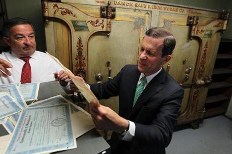 First Deputy Treasurer Jim MacDonald (left) and state Treasurer Steven Grossman examined documents in the vault of the State House before the safe behind them was opened.
