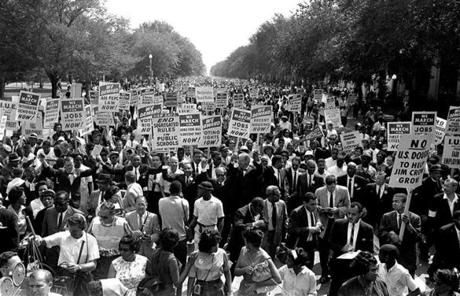 FKing (center left, with arms raised) marched along Constitution Avenue with other civil rights protesters.
