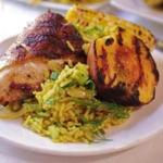 Grilled chicken with peaches and honey-butter corn rice pilaf with cashews and herbs. 