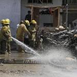 Firefighters cleaned the site of a suicide bombing at a bank in Afghanistan’s Kandahar province.