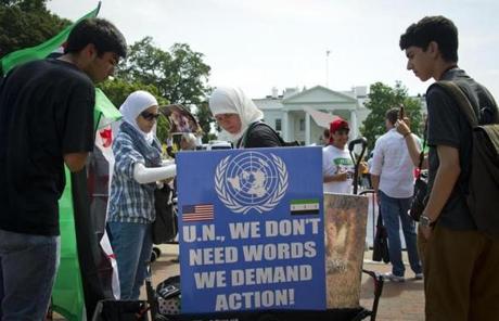 Anti-Assad demonstrators held signs blasting the UN. 

