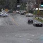 Boston Police shut down traffic on Spring Street near Powell and Summer Streets in West Roxbury due to flooding on Sunday morning.