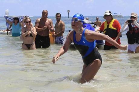 US long-distance swimmer Diana Nyad , 64, walked to dry sand, completing her swim from Cuba as she arrives in Key West.
