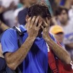 Roger Federer walks off the court, seemingly in disbelief, after losing in three sets to Tommy Robredo in the fourth round of the US Open. REUTERS/Eduardo Munoz 