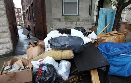 Trash left outside behind a building by former tenants wais piled up near the curb on Brainerd Road on Sunday.
