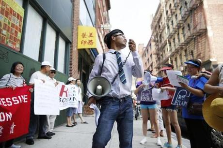 Changling Zhang, 18, of Malden, played the role of a developer during a rally for affordable housing in Chinatown. 

