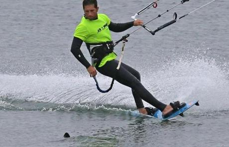 Kitesurfer Avi Levy looked over as he passed by a fin in the water in Pleasure Bay, South Boston.
