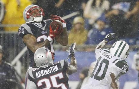 Cornerback Aqib Talib (left) intercepted a pass intended for Jets wide receiver Santonio Holmes during the fourth quarter.
