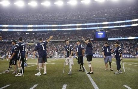 Wounded veterans and Marathon bombing survivors who lost limbs were honored on the field before the game.
