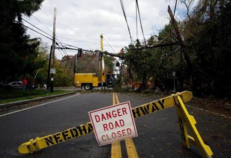 Needham public works crews removed a tree from power lines and traffic lights after Hurricane Sandy passed through last year.
