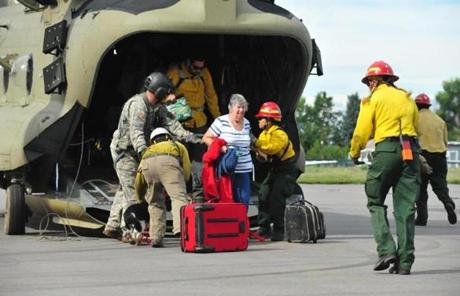 Colorado National Guardsmen and civilian rescue personnel dropped off evacuated residents from Colorado flood zones at the Boulder Municipal Airport.
