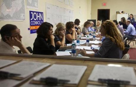 Volunteers for John Connolly worked their cellphones before a meeting in the Roslindale field office.
