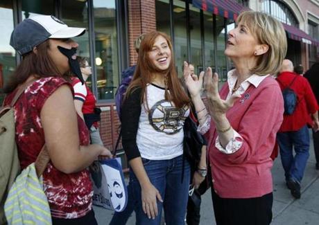 Martha Coakley chatted with Berklee students Angelica Franzino (left) and Carly Tefft while campaigning outside Fenway Park, which had become emblematic of her failed US Senate run.
