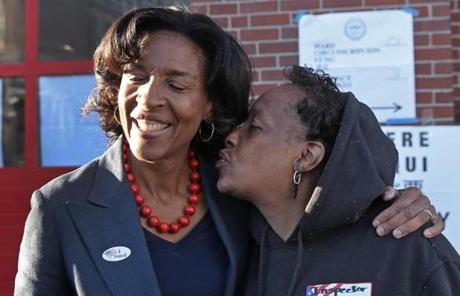 Mayoral candidate Charlotte Golar Richie (left) got a kiss outside a Boston firehouse..
