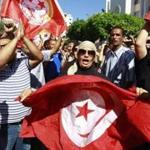 Anti-government protesters wave Tunisian flags as they called for the dissolution of the Islamist-led government this week. 