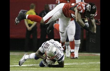 The Falcons' William Moore flew over Kenbrell Thompkins during the second half.
