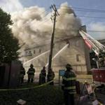 Firefighters battled a four-alarm fire in the Quincy Masonic Temple on Hancock Street on Monday.