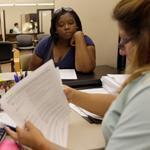 Harris Health counselor Lillian Ardon (right) helped Vanessa Cotton with her insurance application Tuesday in Houston.