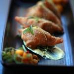 At Opus, samosa-esque turnovers are filled with curried potato.
