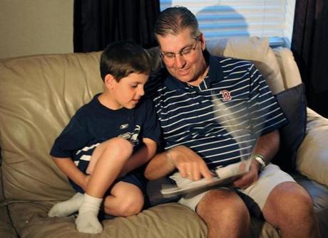 Leo Finn with son Cash. Finn had a bone scan canceled at Dana-Farber.
