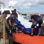 The body of a drowned migrant was unloaded from a Coast Guard boat in the port of Lampedusa, Sicily.