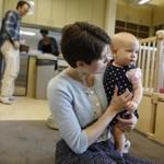 MIT graduate students Chris and Elizabeth Follett with 10-month-old Marie at the new day-care center. Chris Follett called day care a “great experience.”