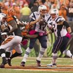 Tom Brady is wrapped up by the Bengals’ Chris Crocker in the fourth quarter, one of four Cincinnati sacks on the day.