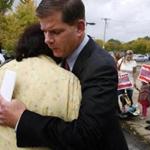 Martin J. Walsh and supporter Delia Baez of Jamaica Plain hugged after he released his plan outside English High.