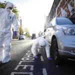 Forensic officers examined a car near where a man was shot dead in Londonderry, Northern Ireland, on Thursday, 