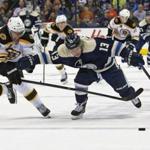 The Bruins’ Reilly Smith and the Blue Jackets’ Cam Atkinson battled for control of the puck in the second period.