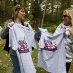 Michelle Daszkiewicz, of Norfolk (left), and Debbie McElroy, of Wrentham, showed off the t-shirts that they bought at Curt Schilling’s estate sale.