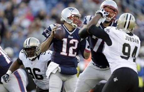 Brady looked for a receiver as the Saints pursued him in the first half.
