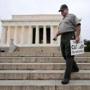 A US park ranger collected “closed” signs on the grounds of the Lincoln Memorial early Thursday after the memorial was reopened to the public, in Washington, D.C.