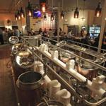 Amateur beer-makers use the copper-jacketed kettles at Hopster’s in Newton to make their own brews.