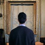 In one of Sophie Calle’s images for “Last Seen,” a man looks at the space where a Rembrandt once hung at the Gardner.
