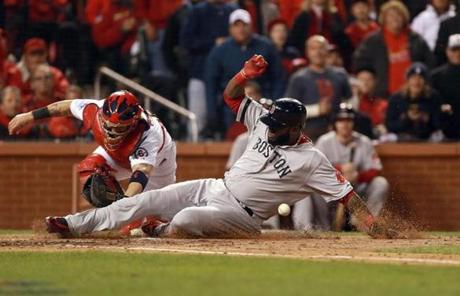 David Ortiz slid to home plate and scored a run for the Red Sox. The game was tied at the end of the top of the inning.
