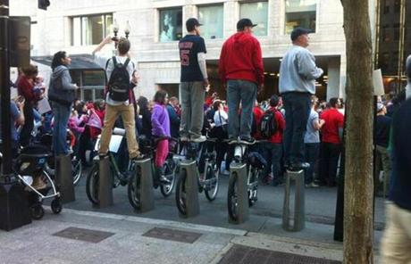 Fans stood atop a Hubway bike station to get a better look at the parade.
