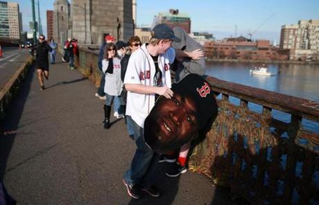 James Breen carried a sign before the start of the parade near the Longfellow Bridge.
