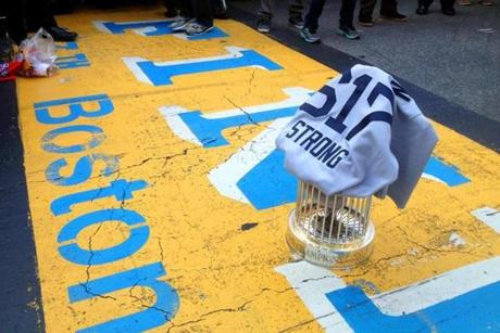 The World Series trophy and a “617 Boston Strong” jersey designed by two Red Sox players were placed on the finish line.
