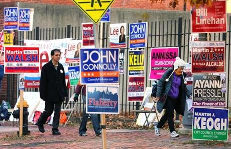 Voters were bombarded with campaign signs outside the Franklin Institute polling place on East Berkley Street in the South End.
