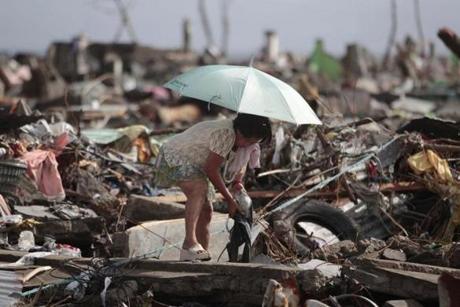 A survivor salvaged belongings from her damaged home in the typhoon-ravaged city of Tacloban.
