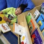 Joon Lim, 2, relaxes with a book at a day-care center run by Bright Horizons, which has been a number one employer three times.