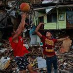 Residents played basketball with a makeshift net in an area of Tacloban, Philippines, destroyed by Typhoon Haiyan, leaving 4 million people displaced.