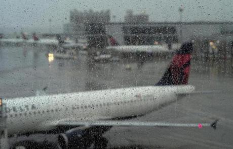 A window was covered in rain at Logan.

